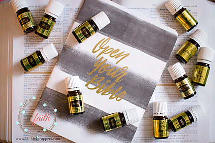 10 oil bottle with golden labels laying upon a black and white striped notebook that says Open Your Bible
